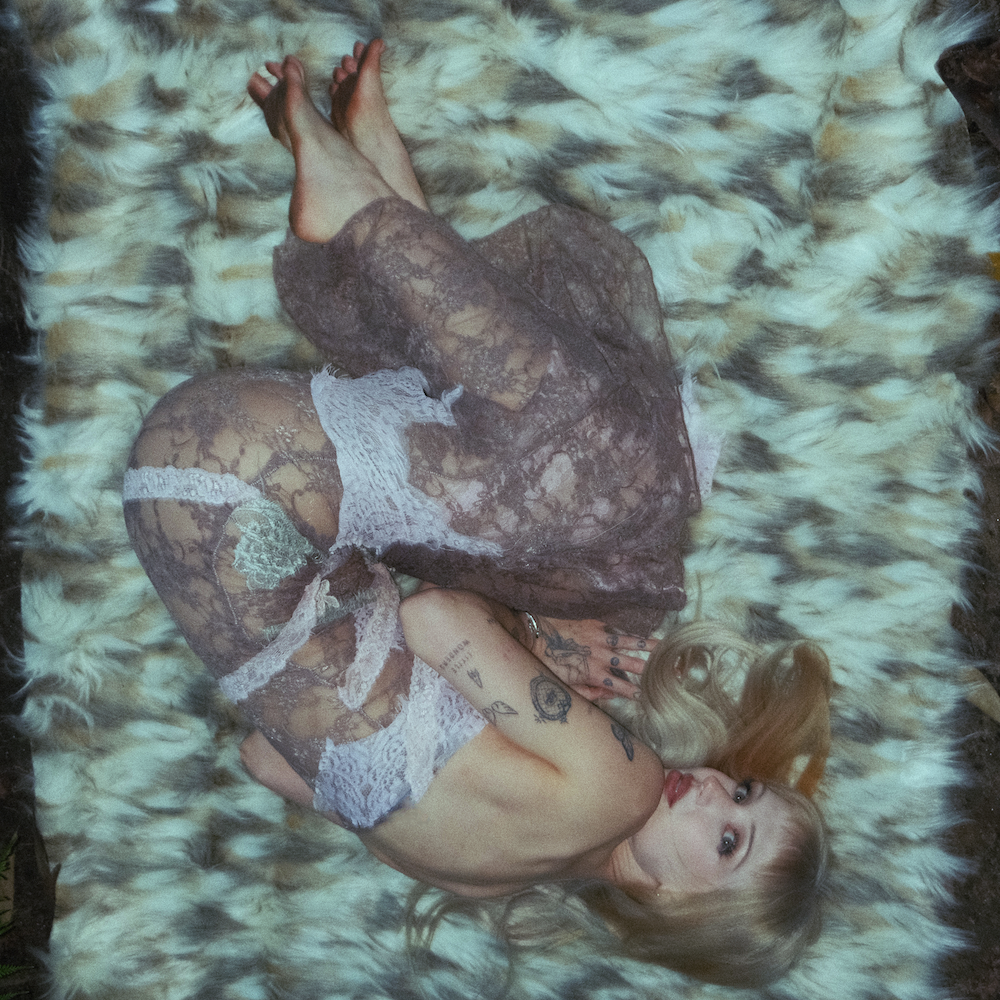 Single cover artwork for Porcelain Kiln by Peach PRC featuring the singer curled up in a lace dress on a faux fur rug.